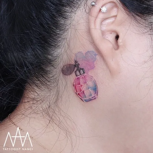Watercolor Perfume Bottle Tattoo Behind the Ear by Tattooist Nanci