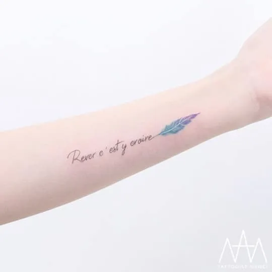 French Lettering and Feather Tattoo by Tattooist Nanci