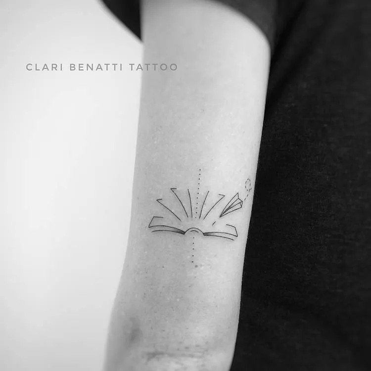 Abstract Book and Paper Plane Tattoo by Clari Benatti