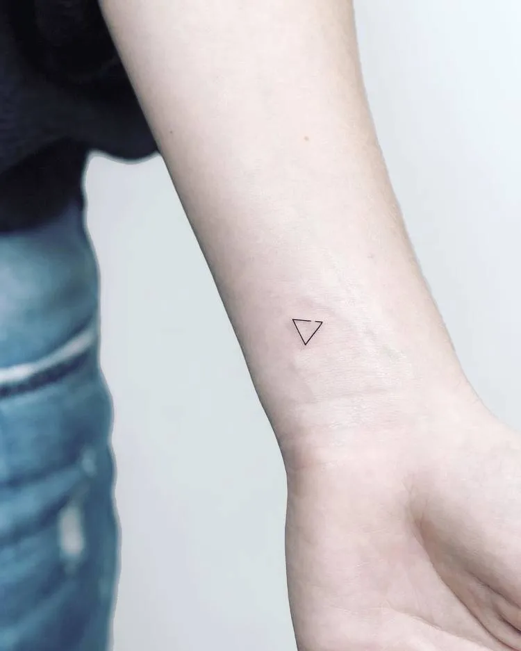 Tiny Triangle Tattoo by Laura Martinez