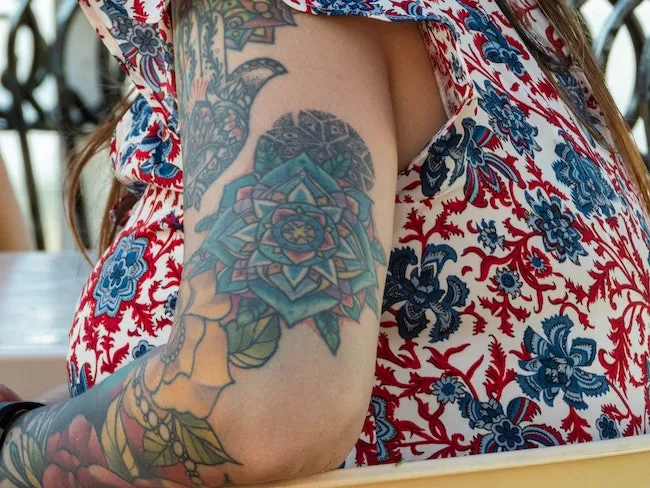 Black vs Color Tattoos - Female arm sleeve in color.