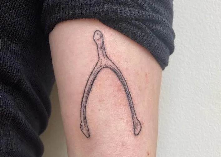 What Does a Wishbone Tattoo Mean, What does a broken wishbone mean, What's the meaning of wishbone, What does the wishbone mean in love, Why is Furcula called wishbone, Is a wishbone good luck, Why is breaking a wishbone good luck, What are the symbols of a wishbone, Wishbone tattoo placement, Wishbone tattoo with flowers,