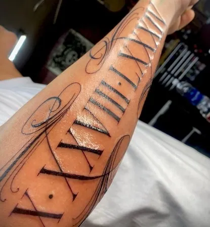 large roman numeral tattoo arm