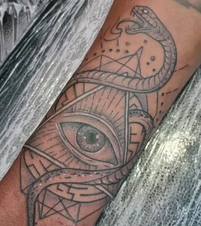 triangle eye tattoo with animal elements