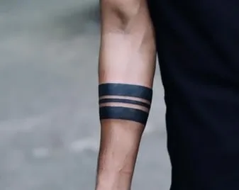 thick black band on arm tattoo idea