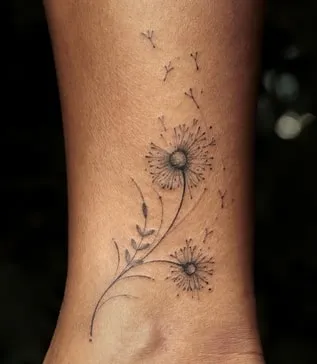 blowing dandelion tattoo
