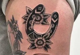 black horseshoe tattoo design idea 