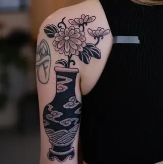 Traditional vase with flowers tattoo Idea