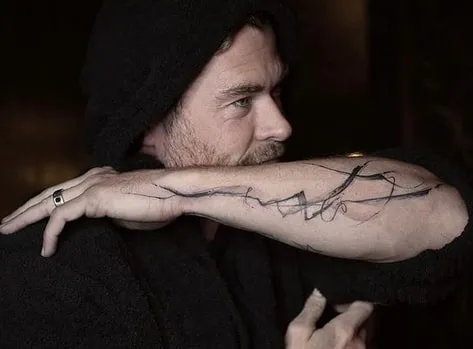 linework tattoo on his arm
